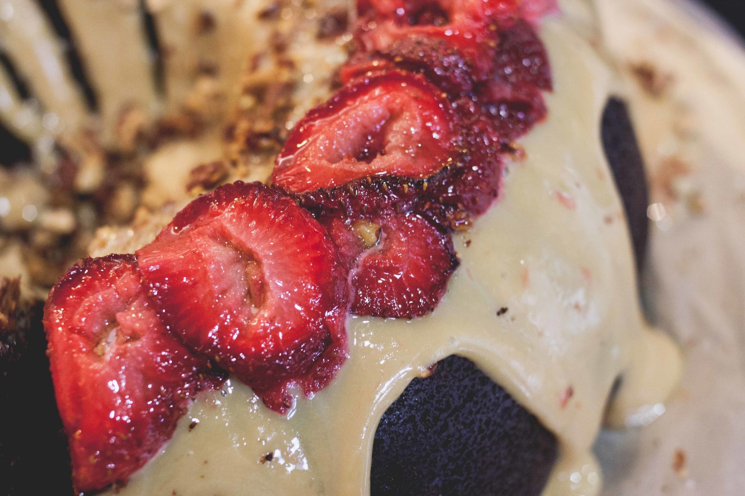 Chocolate whiskey coffee cake topped with salted dulce de leche, olive oil & sea salt roasted strawberries and toasted pecans